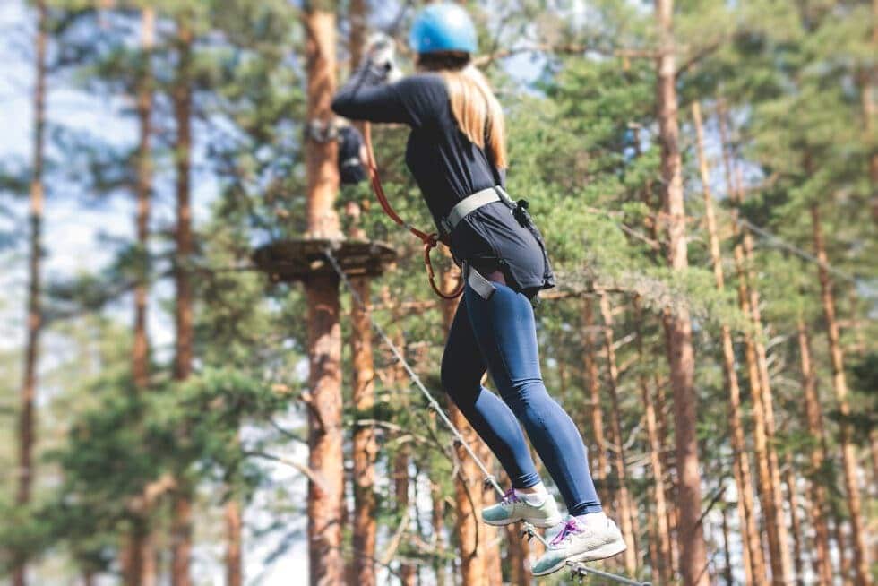 Tripps Now features a canopy tour experience where visitors move between treetops while exploring the surrounding forest.
